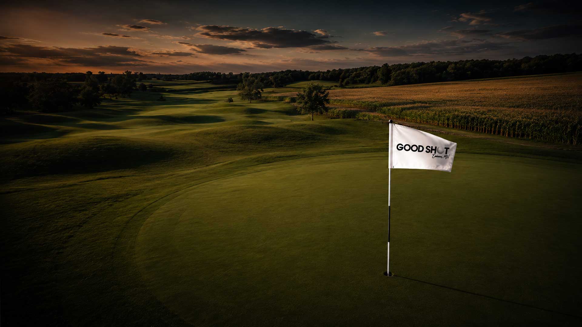 Golf course at sunset with the Good Shot flag